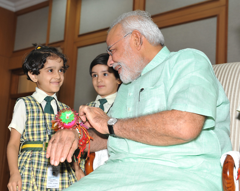 Women, children tie Rakhi on PM's wrist on Raksha Bandhan